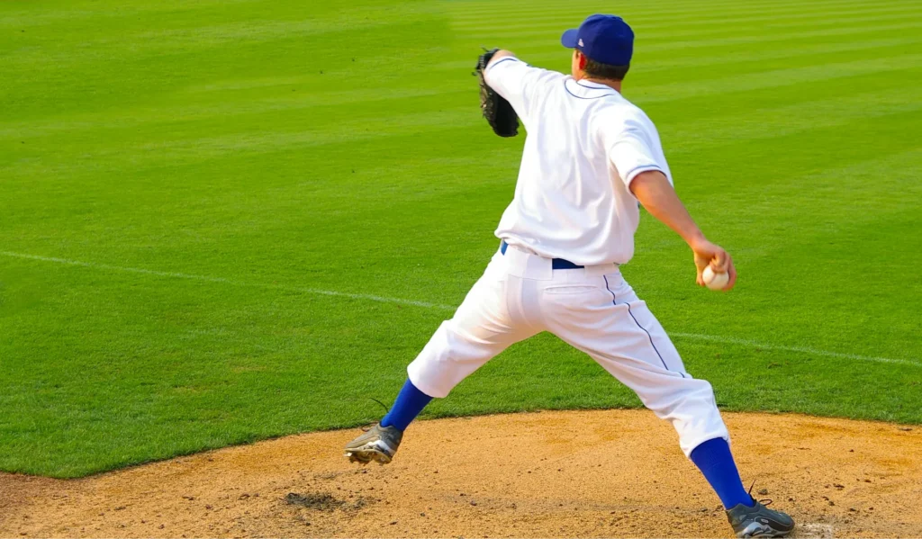 Pitcher's throwing arm in the cocking phase, showing extreme shoulder external rotation.