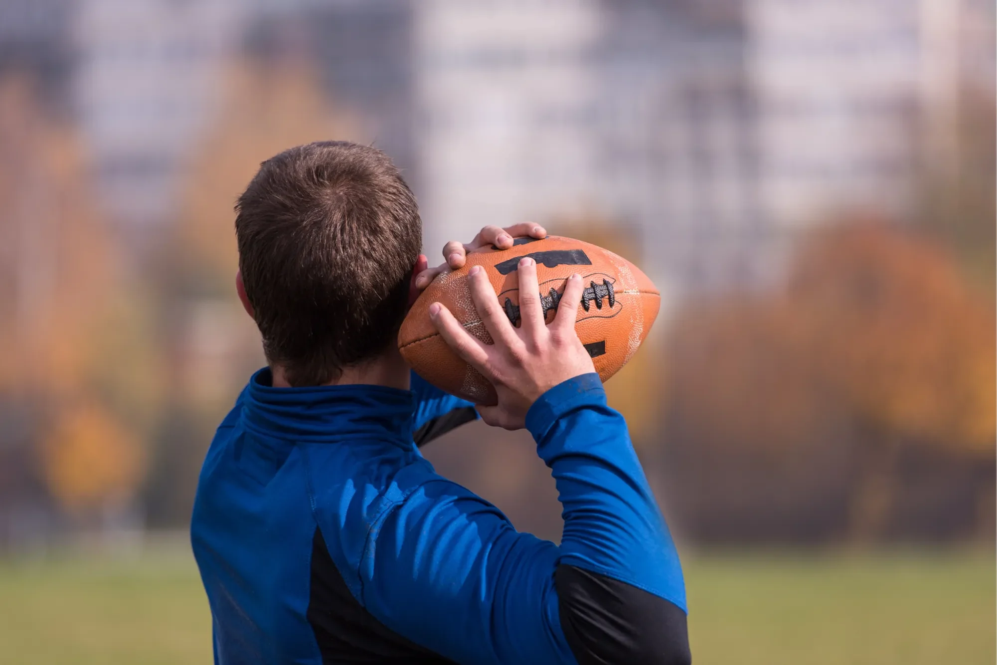 Athlete reaching overhead with an extended arm, the kind of repeated overhead loading that can injure the shoulder labrum